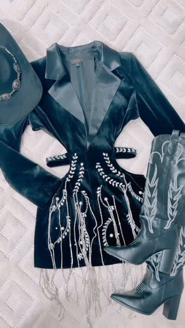 Black velvet mini dress with silver sequins and fringe, paired with black cowboy boots and a hat.